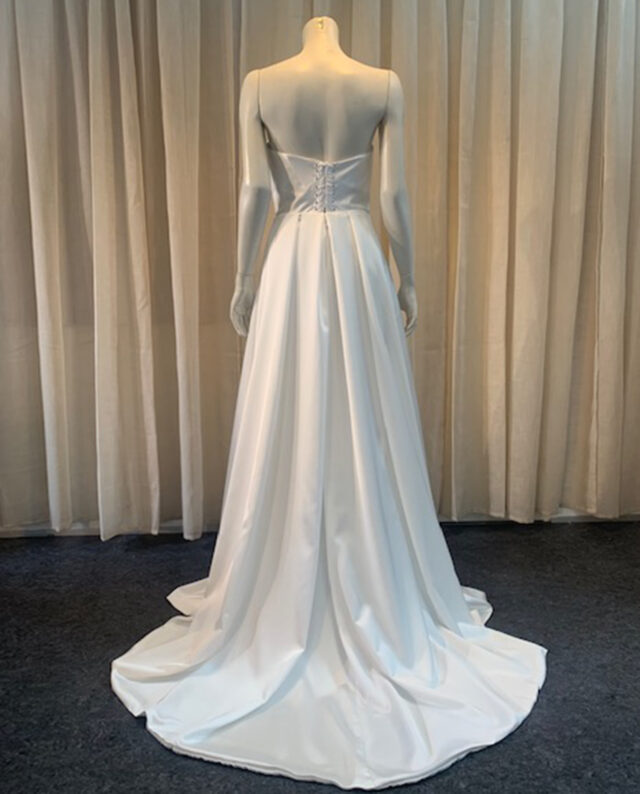 Elegant draped satin corset dress with a bold high split – the perfect balance of glamour and sophistication. Designed by Rikke Gudnitz