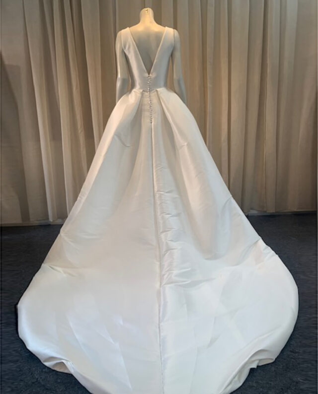 A stunning Mikado gown featuring a deep V-neckline and a high split for a refined yet modern look. The dress is not an original Gudnitz Copenhagen design